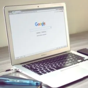 A laptop open to the Google hompage.