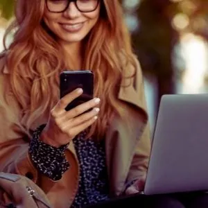 A woman uses her phone to find the product she wants.