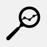 A magnifying glass showing an upward trending graph.