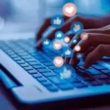 Like emojis rising as a person types on a laptop.