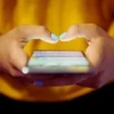 A person typing on their phone using social media.