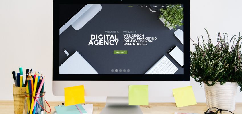 Modern digital agency with website matching colors displayed on a desktop in a stylish office setting.