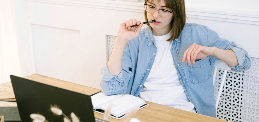 The woman is thinking of strategies to get her website featured on the first page of Google SERP.