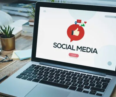 A laptop has a social media background.