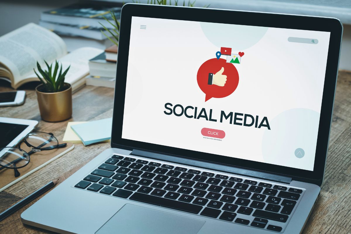 A laptop has a social media background.