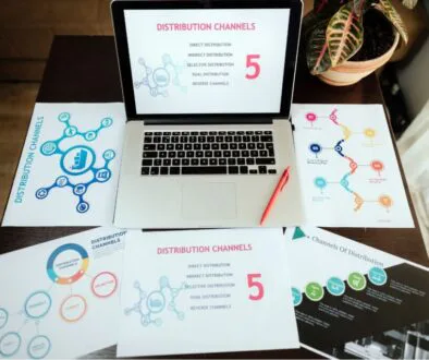 Laptop and hard copy materials discuss digital marketing channels.