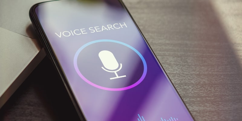 A mobile phone displaying voice search which is a future trend in a full service marketing agency