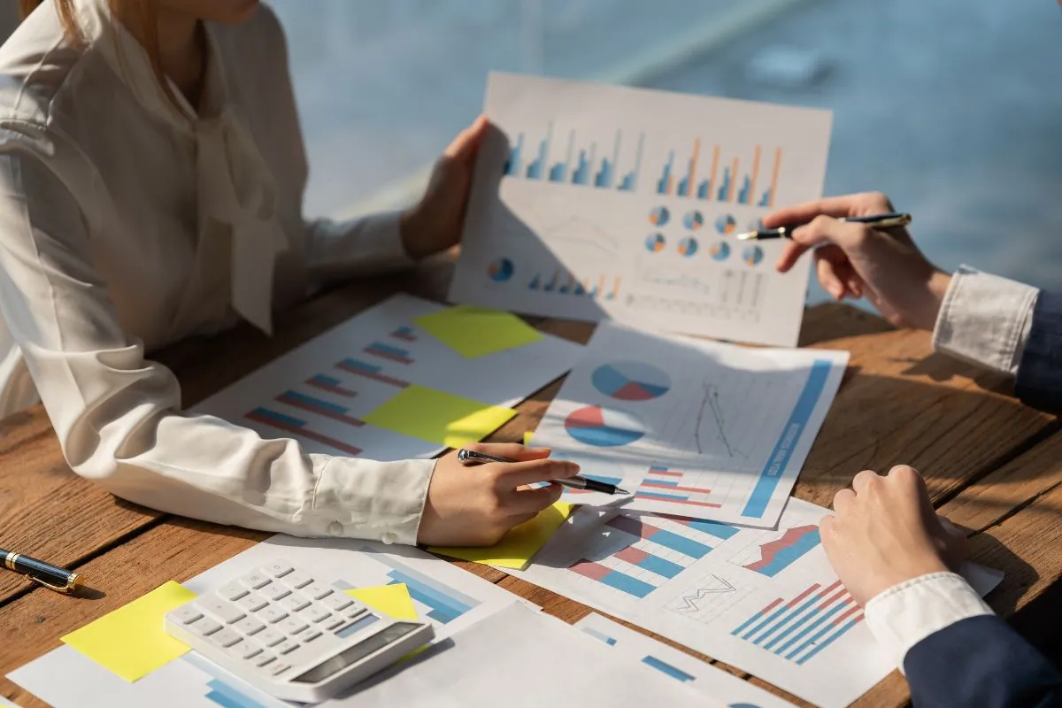 Two people discussing marketing activities through graphs