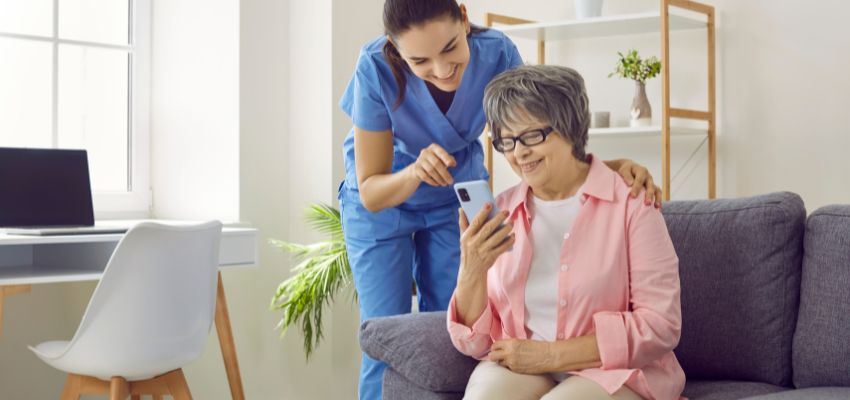 A nurse and a patient looking into healthcare SEO on a mobile phone