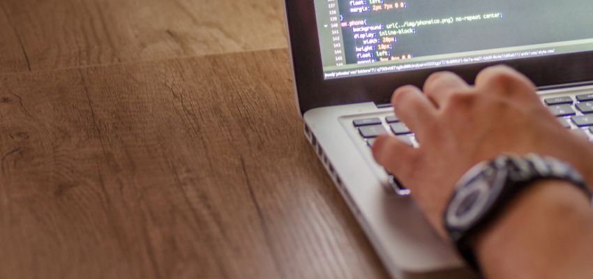 The man is creating a web application.