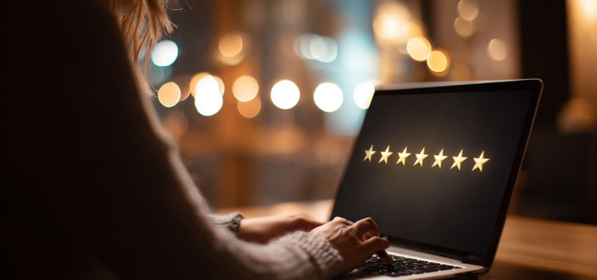 The woman is creating an online review.